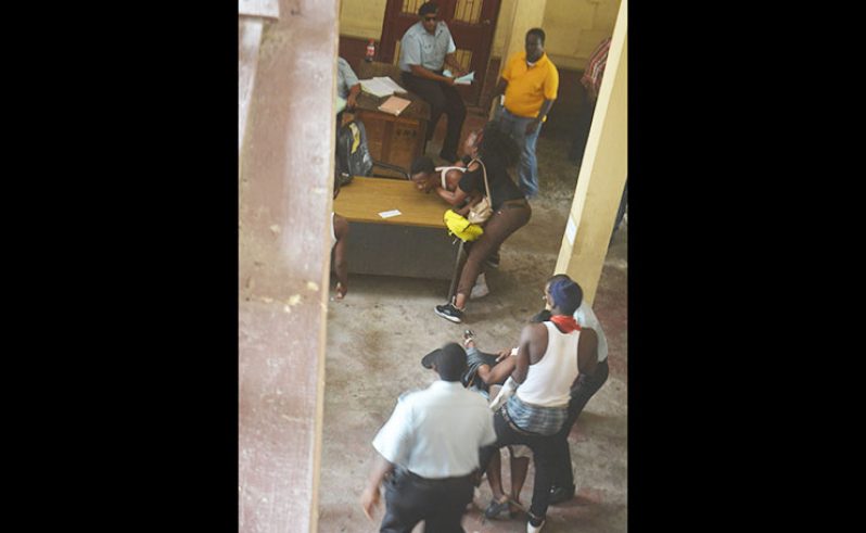 Trapp being restrained by a relative outside the prisoner’s holding cell