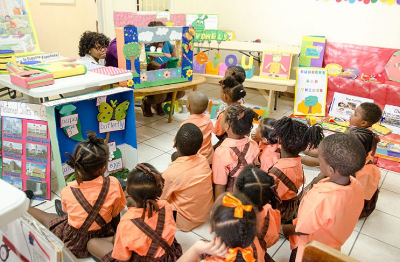 Children enjoying a puppet show by the teachers
