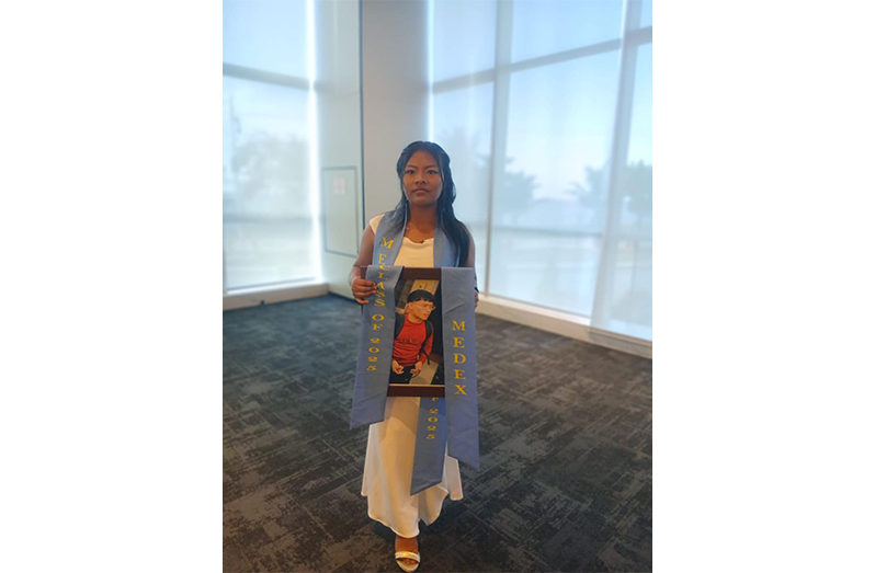 Trevorlene John with her late best friend, Shemron Ayau’s photo at the graduation ceremony