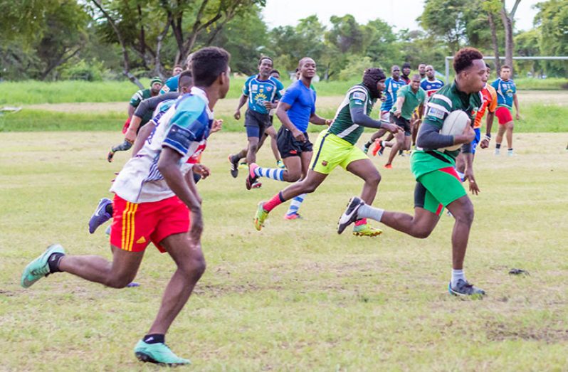 Lancelot Adonis runs with the ball during a play in yesterday’s North Vs South XV game at the National Park (Delano Williams photos)