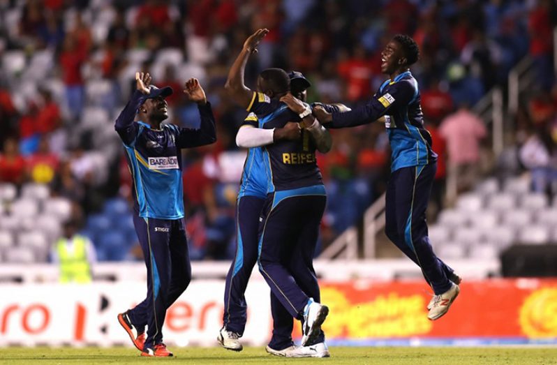 Barbados Tridents players celebrate their victory over TKR last evening.