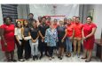 Trinidad and Tobago athletes and representatives share a photo after collecting their monetary rewards for medalling at the Central American and Caribbean (CAC) Games in Santo Domingo