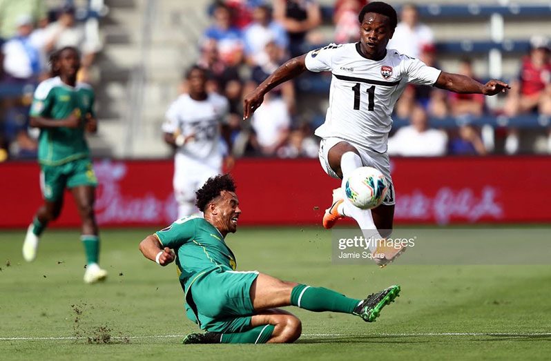 CAPTION: FLASH BACK! Levi Garcia of Trinidad and Tobago controls the ball as Samuel Cox of Guyana attempts to slide tackle during the first half of the CONCACAF Gold Cup match at Children's Mercy Park on June 26, 2019 in Kansas City, Kansas. (Photo by Jamie Squire/Getty Images)