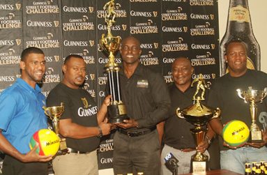 Here we go again! From left, Errol Nelson, Troy Mendonca, Lee Baptiste, Troy Peters and Wayne ‘Harry’ Griffith smile broadly as they display the four top place trophies which will be up for grabs during this year’s edition of the ‘Guinness Greatest of De Streets’ Futsal football competition  (Photo by Cullen Bess-Nelson)
