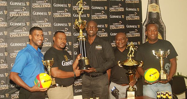 Here we go again! From left, Errol Nelson, Troy Mendonca, Lee Baptiste, Troy Peters and Wayne ‘Harry’ Griffith smile broadly as they display the four top place trophies which will be up for grabs during this year’s edition of the ‘Guinness Greatest of De Streets’ Futsal football competition  (Photo by Cullen Bess-Nelson)