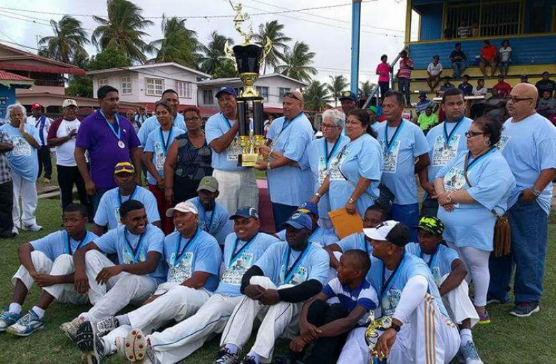 Flashback: Winning captain of Young Warriors Cricket Club, Hubern Evans, collects the trophy from Mukesh Appiah, son of the late Ramnarine Appiah.