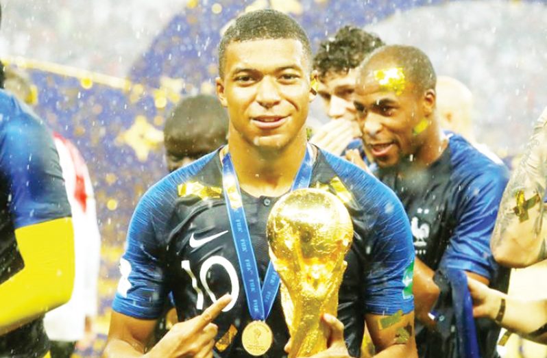 France's Kylian Mbappe celebrates with the trophy after winning the World Cup REUTERS/Kai Pfaffenbach