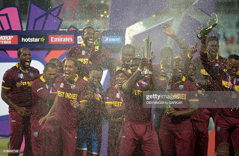 West Indies captain Darren Sammy (C) holds the trophy after winning the World T20 cricket tournament final match between England and West Indies at The Eden Gardens Cricket Stadium in Kolkata on April 3, 2016 (Photo credit: DIBYANGSHU SARKAR/AFP via Getty Images)