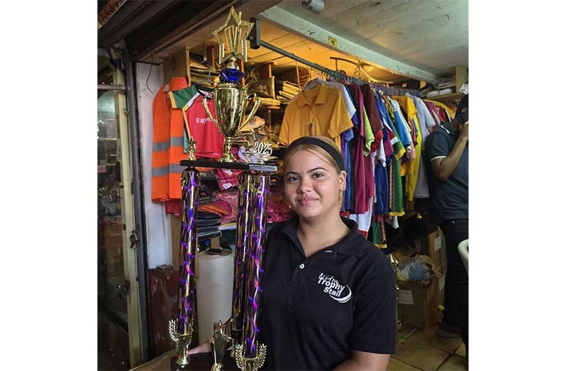 Lilyana Reve Quesada, a representative of Trophy Stall poses with one of the trophies up for grabs in today’s tournament