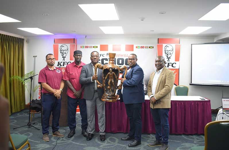 (from left to right) Nicholas Fraser - Head of the Unit of Allied Arts, Trophy sculptor - Rodwell Thom, Franklyn Wilson - Assistant Director of Sports, Troy Mendonca Petra Co-Director and Troy Peters - Petra Rep unveils the trophy