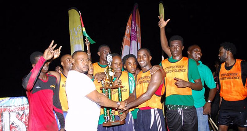 Tournament winners Tucville collect their trophy from Petra director Troy Mendonca after beating North East La Penitence 2-1 on penalties. (Delano Williams photo)