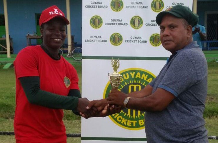 Tremayne Smartt (at left) collects her player-of-the-match award from match referee, Moses Ramnarine.