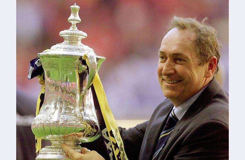 FILE PHOTO: Soccer Football - FA Cup Final - Liverpool v Arsenal - Millennium Stadium, Cardiff, Wales, Britain - May 12, 2001 Liverpool's manager Gerard Houllier holds aloft the FA Cup REUTERS/Ian Hodgson.