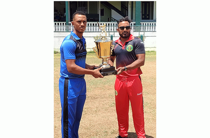 Demerara skipper Tevin Imlach (left) and Berbice Captain Veerasammy Permaul share a moment with the Intercounty trophy