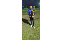 Dr Joel Dilchand poses with one of his many cricketing trophies