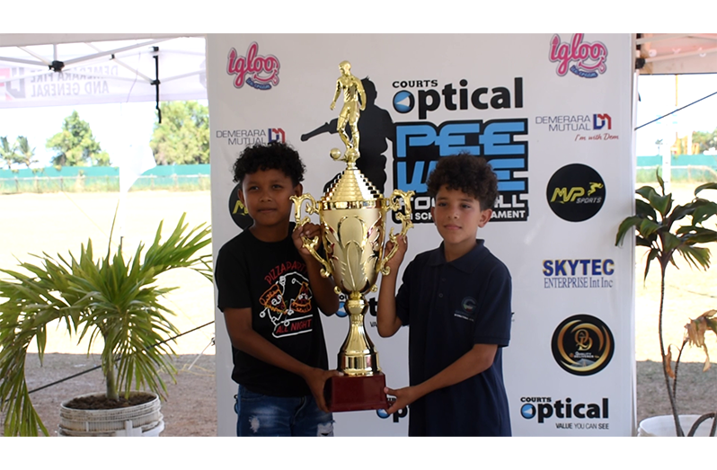 Players pose with trophy up for grabs today. (Left to right) Riyad Peters, a Waramuri player, and Yoseph Rivas, a GIA player