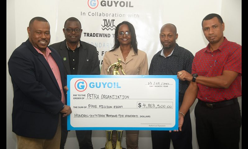 Petra Organisation co-Director Troy Mendonca (left) receiving the sponsorship cheque from Berkeley McCalman, GUYOIL Bulk Sales Executive, in the presence of Assistant Director of Sport Melissa Richardson (centre), GFF Technical Director Bryan Joseph (2nd from left), and Head of the Physical Education department at the Ministry of Education, Kirk Brathwaite (Adrian Narine photo)