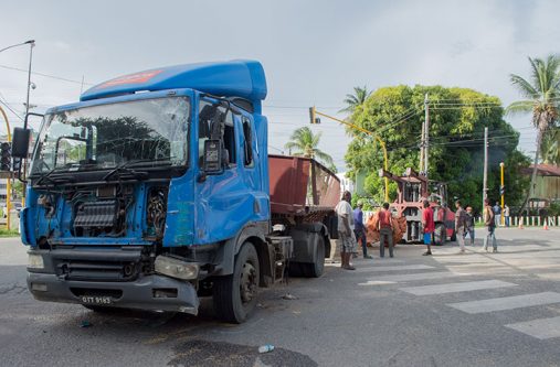 The paddy-laden truck which flipped on its side after it collided with a motor lorry, killing two cows and injuring two persons (Samuel Maughn Photo)