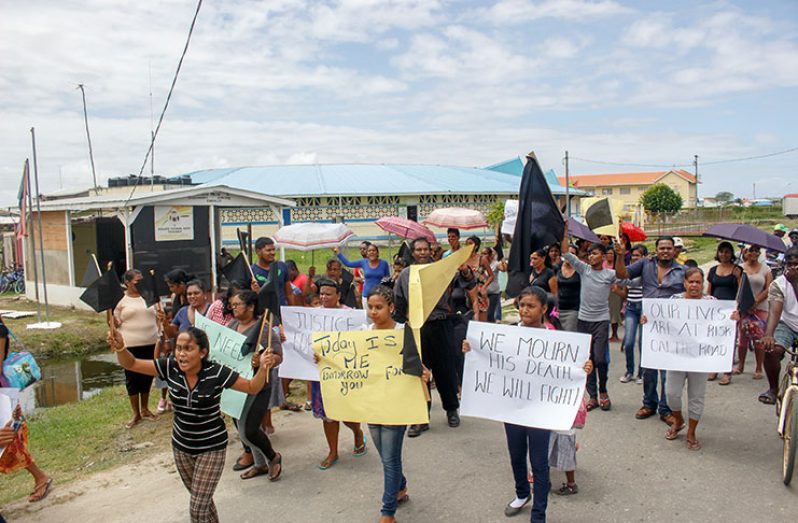 Mother of the victim, Anna Persaud, leads the protest outside the Tuschen Police Outpost (Samuel Maughn photo)