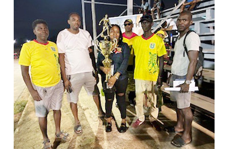 UDFA officials pose with winning trophy for the year-end futsal tournament at Retrieve Hard Court. Holding the trophy is UDFA’s PRO Ms. Recia Nedd