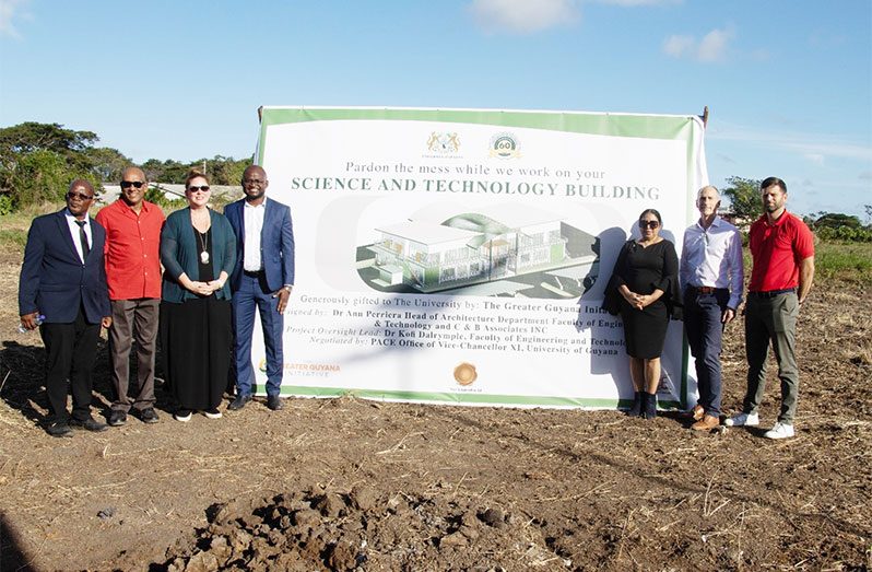 Senior officials of the University of Guyana and the Greater Guyana Initiative (GGI) pose for a photo at the site of the new Science and Technology building