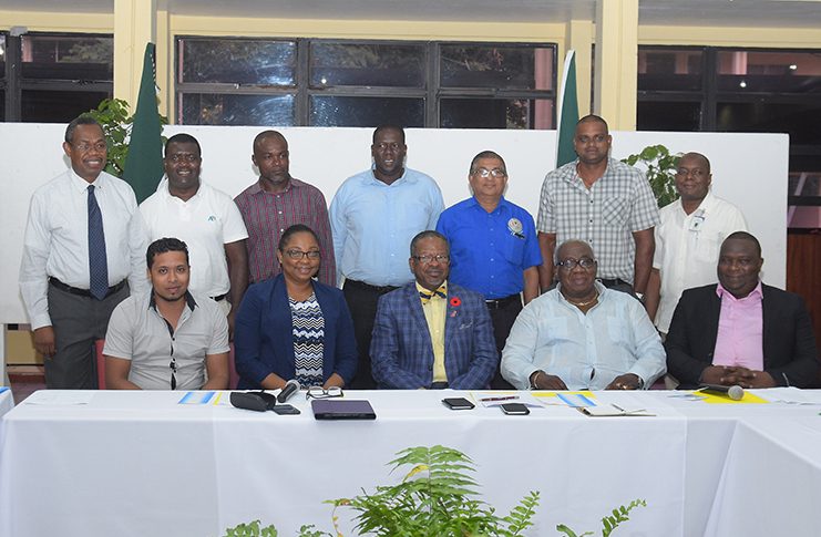Vice Chancellor of the University of Guyana (UG) Professor Ivelaw Griffith (at centre, seated), flanked by representatives of the various local technical institutions which signed on to the HECEM (Samuel Maughn photo)