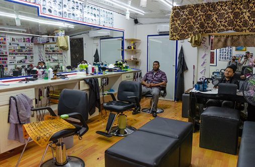 The guys at the Lifestyle Barbershop with nothing else to do but enjoy cricket on the television