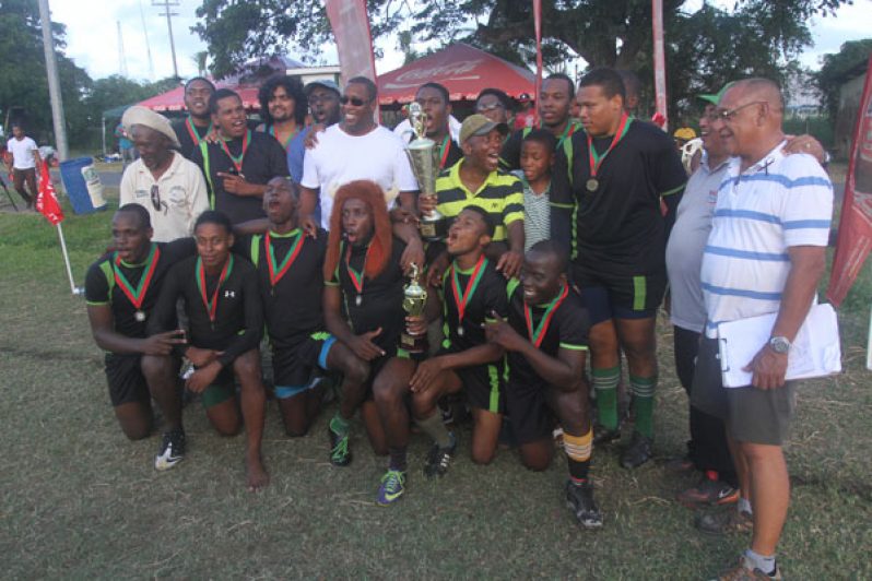 The victorious UG Wolves celebrate after winning the Banks DIH 7s tournament yesterday (Sonell Nelson photo)