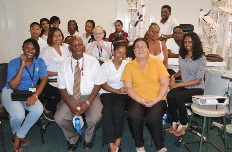 Dr. Emanuel Cummings (front second left), Dean of the Faculty of Health Sciences at the University of Guyana, shares a moment with optometry students during a tour of the faculty on Friday at the Turkeyen Campus