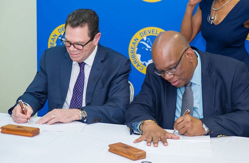 President of the CDB, Dr Warren Smith and Minister of Finance Winston Jordan signing the Technical Assistance Grant in Grenada on the sideline of the CDB 48th Board of Governors Meeting in Grenada.