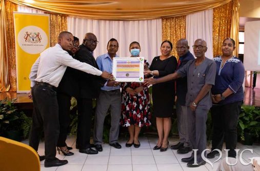 From R-L: Dr Diana Gobin, Deputy Vice-Chancellor, Finance; Dr Nigel Gravesande, Registrar, UG; Dr Emanuel Cummings, Deputy Vice-Chancellor, Academic Engagement; Vice-Chancellor, Professor Paloma Mohamed Martin; Priya Manickchand, Minister of Education; Dr Mohandat Goolsarran, Chair of the National Accreditation Council (NAC); Dr Marcel Hutson, CEO of the National Accreditation Council; and Dr Jacqueline Maurry, Director of IDCE, receive the Accreditation certificate from the National Accreditation Council at a ceremony held at the Education Lecture Theatre (ELT) at UG’s Turkeyen Campus