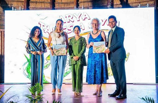 First Lady Arya Ali flanked by British High Commissioner to Guyana, Jane Miller who receives a copy of the audiobook from managing director of EMC, Shyam Nokta and other local collaborators
