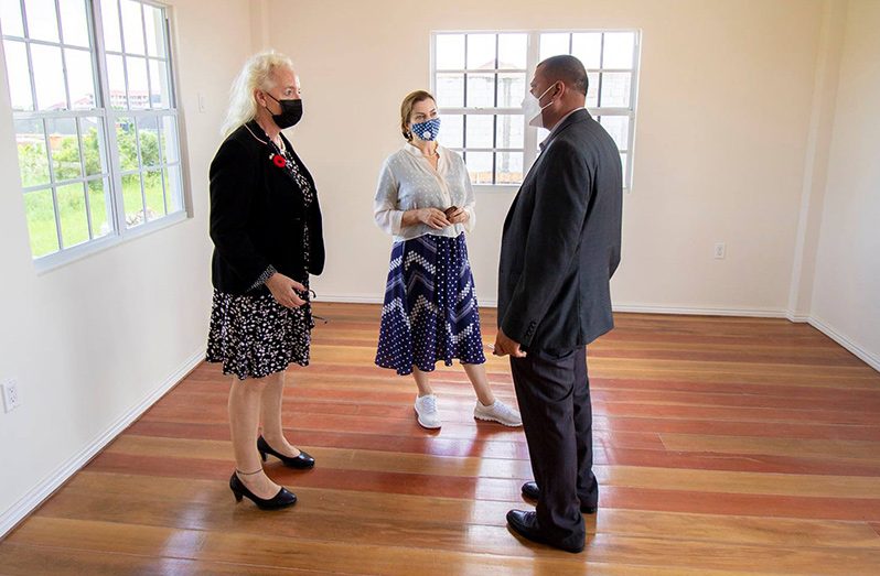 Minister of Housing and Water, Collin Croal (right), interacts with British High Commissioner, Jane Miller (left), and Caribbean Regional Director, Laura Ferguson, during a brief tour of the agency’s housing units along the East Bank of Demerara