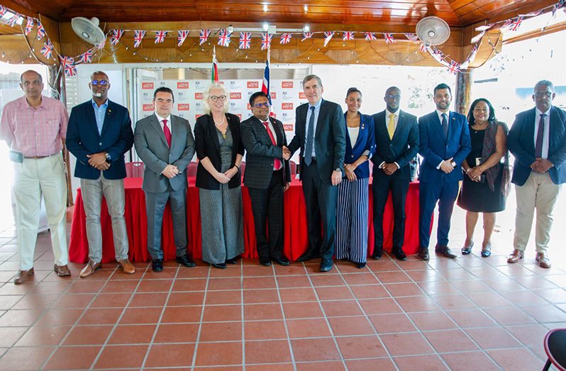 Senior Minister in the Office of the President with responsibility for Finance and Public Service, Dr Ashni Singh (centre) shakes the hand of UK Minister for the Americas, Caribbean and Overseas Territories, David Rutley, among other prominent officials Tuesday