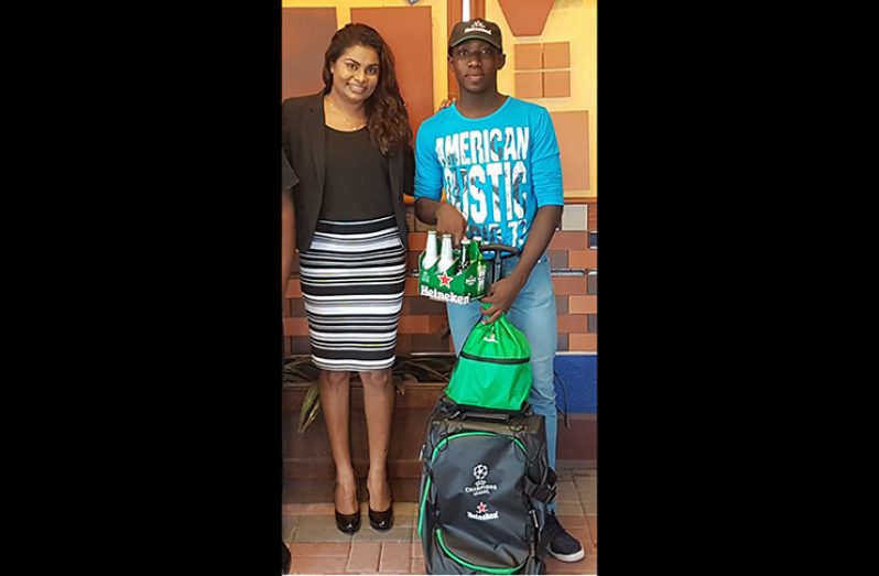Heineken Portfolio Manager, Darshanie Yussuf stands with winner of the Ultimate Heineken Race, O’Neil Powers.