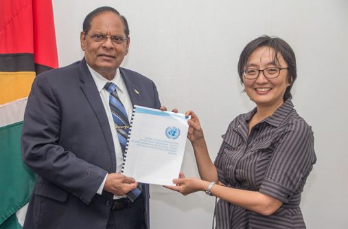 UN Resident Coordinator, Mikiko Tanaka, presenting the report to Prime Minister Moses Nagamootoo
