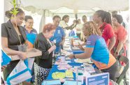 UN open day (3) Minister Gail Texeira, along with UN Resident Coordinator Jean Kamau, interacts at the PAHO booth (Delano Williams photos)