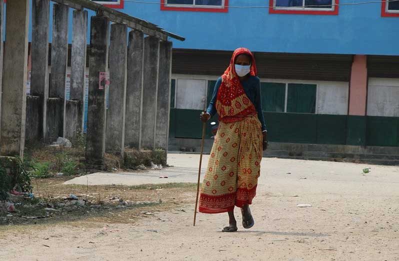 Older women, in particular, face additional challenges and prejudice due to ageist attitudes and discrimination. Pictured here, a 69-year-old woman walks in a village in Nepal (UNICEF/Preena Shrestha)