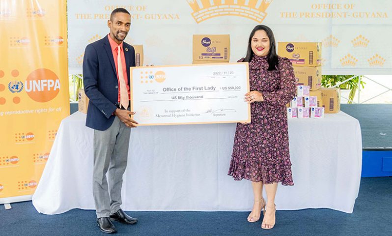 UNFPA Liaison Officer for Guyana, Adler Bynoe delivers the sponsorship cheque to First Lady Arya Ali (Office of the First Lady photo)