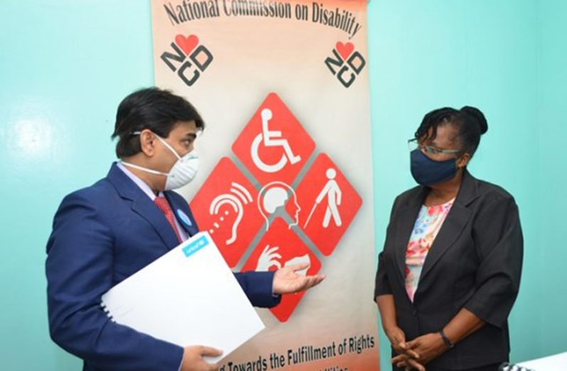 UNICEF representative Irfan Akhtar conversing with Executive Secretary to the National Commission on Disability, Beverly Pile