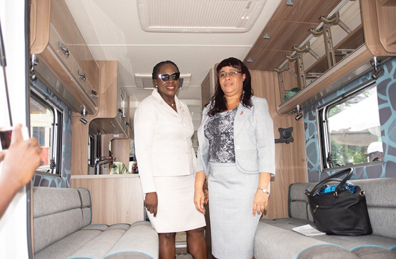 Minister Henry and Permanent Secretary, Ms  Adele Clarke examine the internal features of the mobile unit (Delano Williams photos)
