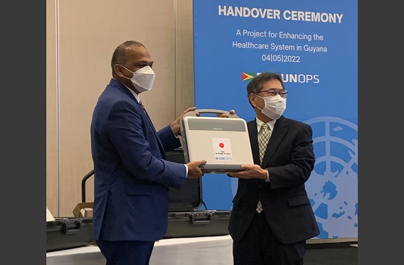 Health Minister, Dr Frank Anthony, receives one of the digital mobile imaging units from Counsellor at the Embassy of Japan in Trinidad and Tobago, Yasuhiko Kamada
