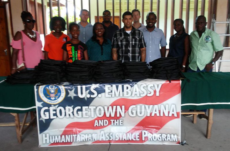 Representatives from the U.S. Embassy and the Linden Mayor and Town Council with one of the beneficiaries