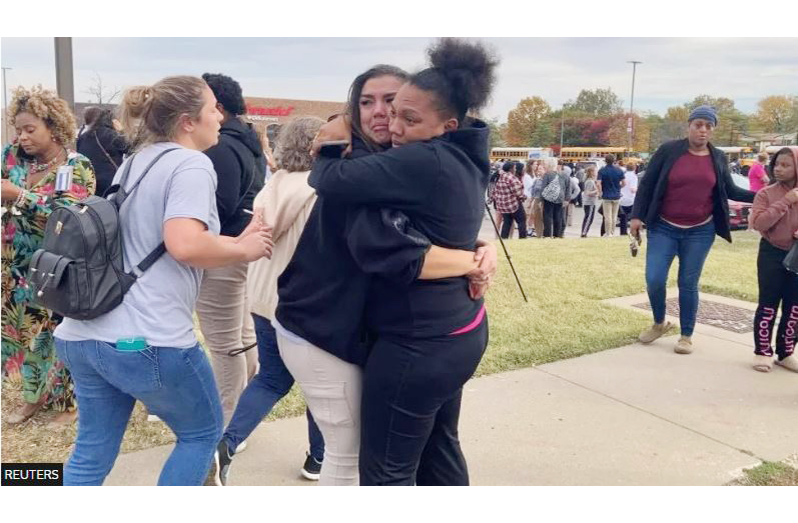 Family members console each other following the shooting