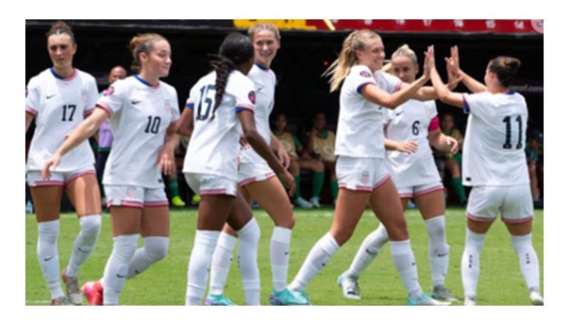 Izzy Engle (third right) of the USA celebrates after scoring one of her four goals against Guyana.