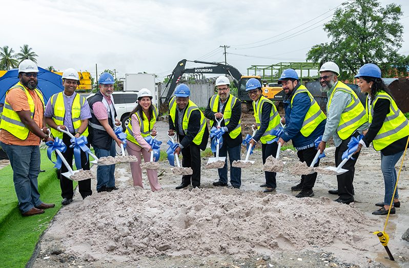 Minister of Tourism, Industry and Commerce, Oneidge Walrond (fourth from right) along with Unicomer representatives, and representatives of the IDB turned the sod, on Friday (Delano Williams photo)