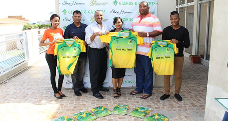 Gizmos and Gadgets Company Secretary, Malicia Gomes, hands over the uniforms to RHTY&SC Secretary/CEO Hilbert Foster in the presence of members of the club and the company.