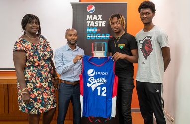 President of the Sonics Basketball Club, Merel Chalmers-Casey; DDL Brands Manager, Larry Wills, and members of the Pepsi Sonics Basketball Club