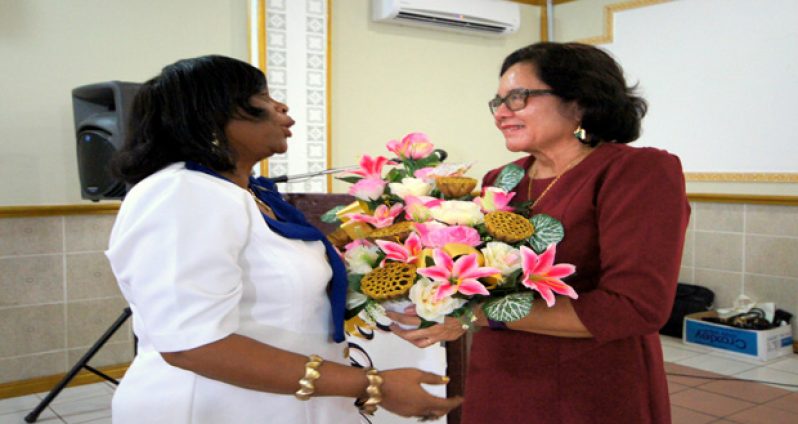 First Lady Sandra Granger receives a bouquet from Ms. Eletrice Davenport.