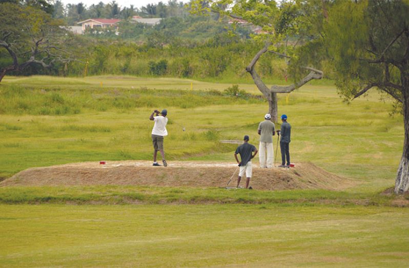 The Lusignan Golf Club on the East Coast of Demerara looks in tip-top shape, as a few golfers put in some final touches for this weekend’s tournament. (Adrian Narine photo)